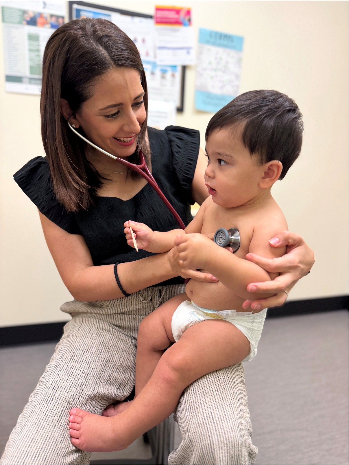Pediatrician listening to a young child's heartbeat with a stethoscope